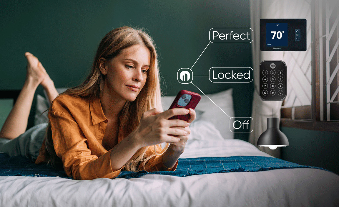 Woman usung smart phone to control her smart lock, smart lights and smart thermostat